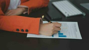 Asian Business woman using calculator and laptop for doing math finance on an office desk, tax, report, accounting, statistics, and analytical research concept video