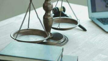 Justice and law concept.Male judge in a courtroom with the gavel, working with, computer and docking keyboard, eyeglasses, on table in morning light video