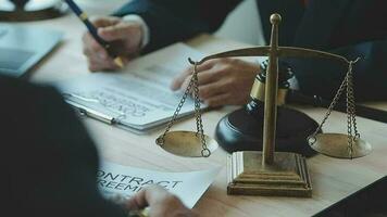 Justice and law concept.Male judge in a courtroom with the gavel, working with, computer and docking keyboard, eyeglasses, on table in morning light video