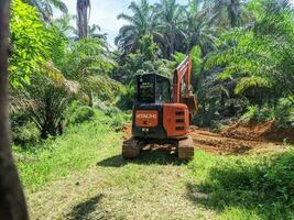 kuaro Kalimantan timur, Indonesia 28 April 2023. Heavy excavator digging soil in oil palm plantation photo