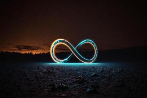 glowing neon infinity symbol in the night. . Infinity, eternity, infinite, endless, loop symbols. photo