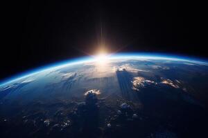 Sunrise view of the planet Earth from space with the sun setting over the horizon. photo