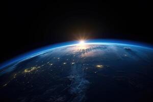 Sunrise view of the planet Earth from space with the sun setting over the horizon. photo