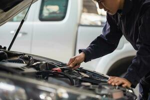 Car mechanic in repair garage, Technician man working in auto repair shop, Car repair and maintenance concepts photo