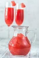 Jug of Mimosa cocktail with grapefruit slices photo