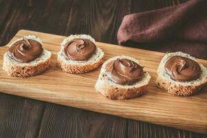 Slices of baguette with chocolate paste photo
