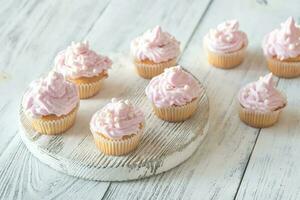 Many pink cream homemade cupcakes photo