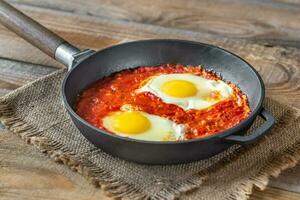 Shakshouka served in a frying pan photo