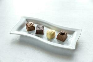 Chocolate candies of different shapes photo