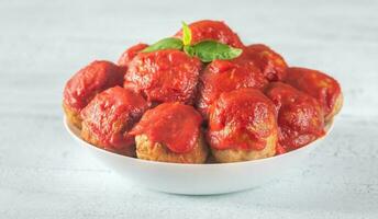 Bowl of meatballs with tomato sauce photo