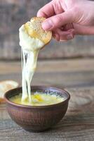 Bowl of cheese dip with toasts photo