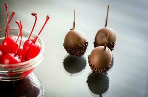 Chocolate and cocktail cherries on the glass photo