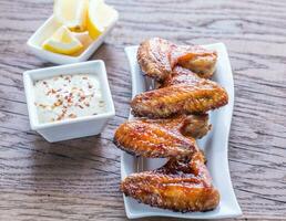 Baked chicken wings with spicy sauce photo