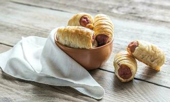 Bowl with sausage rolls photo