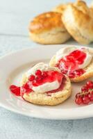 Classic scones with cream and berry jam photo