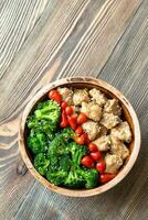 Bowl of broccoli and chicken stir-fry photo