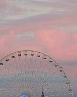 Ferris wheel against blue cloudy sky on sunny weather background photo