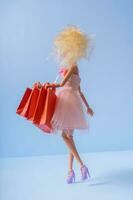 Sale shopping concept. Doll with shopping bags photo