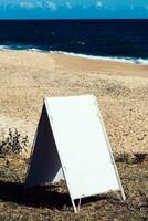 Empty signboard on an empty tropical beach photo