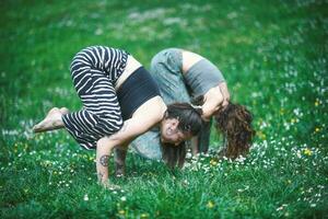 Acrobatic yoga position with female couple photo