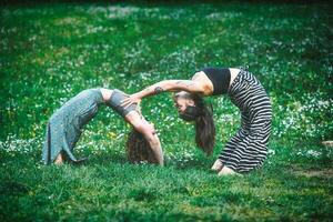 Couple of young women in a sports yoga pose photo