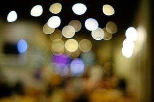 Abstract Blurred Restaurant Background with Bokeh and Flare. photo