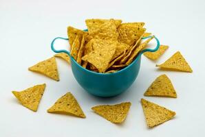 Nachos in a plastic bowl. Tortilla chips isolated on white background. photo