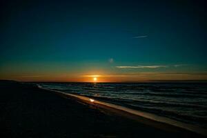 picturesque calm sunset with colorful clouds on the shores of the Baltic Sea in Poland photo