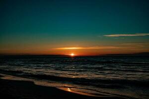 picturesque calm sunset with colorful clouds on the shores of the Baltic Sea in Poland photo