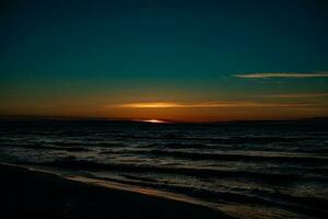 picturesque calm sunset with colorful clouds on the shores of the Baltic Sea in Poland photo