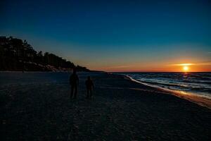 picturesque calm sunset with colorful clouds on the shores of the Baltic Sea in Poland photo