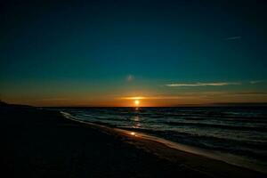 picturesque calm sunset with colorful clouds on the shores of the Baltic Sea in Poland photo