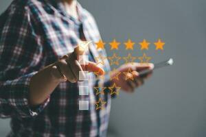 Customer experience with customer service and satisfaction concept. Woman finger touching on five star excellent rating on background, copy space, Customers show satisfaction and quality of services. photo