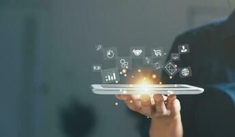 Businesswoman hand working on tablet and smart phone with virtual icon. Business internet connection application technology and digital marketing, Financial and banking, Digital link tech, big data. photo