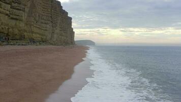 West Bay Tall Sandstone Cliffs Next the Sea in England video