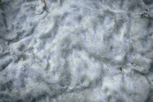 Background of white dirty cotton wool from old matress stuffing close up top down view photo