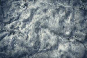 Background of white dirty cotton wool from old matress stuffing close up top down view photo