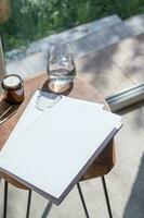 Magazine and book mockup design. Blank magazine on modern wooden table with candles , shadow overlay photo