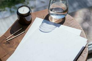 Magazine and book mockup design. Blank magazine on modern wooden table with candles , shadow overlay photo