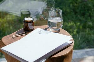 Magazine and book mockup design. Blank magazine on modern wooden table with candles , shadow overlay photo