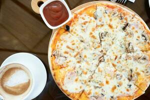 italian chicken pizza with mozarella cheese on glass table in street cafe photo