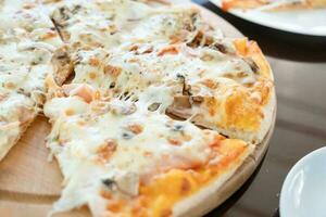italian chicken pizza with mozarella cheese on glass table in street cafe photo