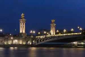 sight of Pont Alexandre III in Paris at night photo