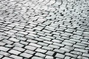 black and white photo of cobblestone road