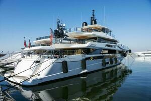 A white luxury yacht moored in a seaport photo