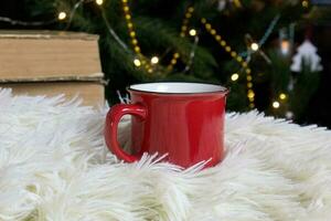 blanco rojo jarra con Navidad árbol en fondo, te o café taza con Navidad y nuevo año decoración,horizontal burlarse de arriba con cerámico jarra para caliente bebidas, vacio regalo impresión modelo foto