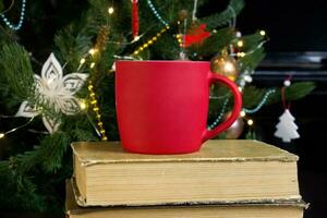 blanco rojo jarra con Navidad árbol en fondo, estera té o café taza con Navidad y nuevo año decoracion,verticales burlarse de arriba con cerámico jarra para caliente bebidas, vacio regalo impresión modelo foto