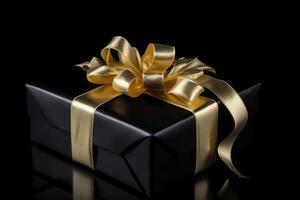 Gift box with golden satin ribbon and bow on dark background. photo