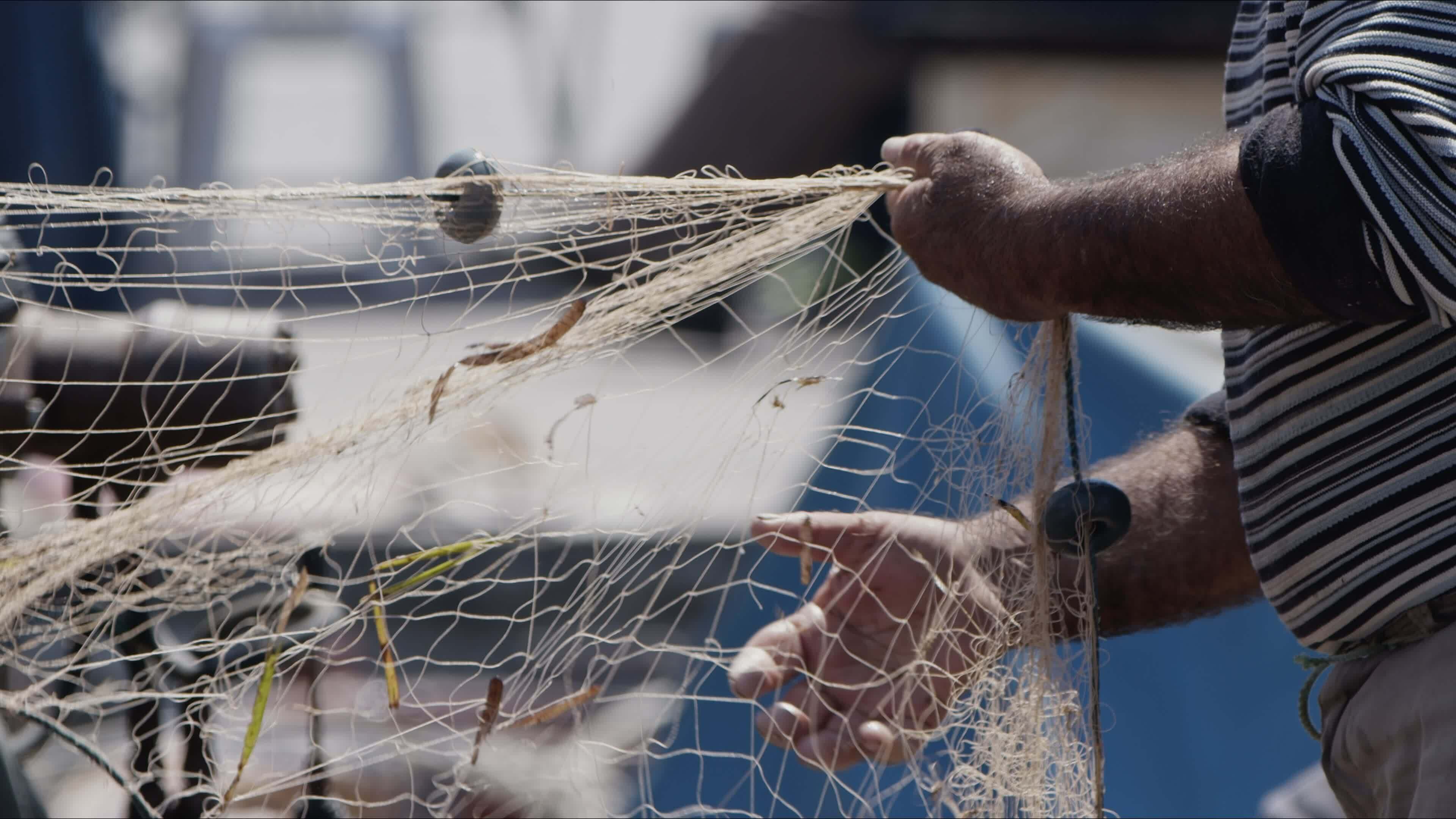 Fisherman is Repairing Fishnets on Fishing Boat in Dock 23502973