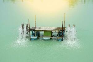 A water turbine while spinning adds air to treat the waste water in the pool. soft and selective focus. photo